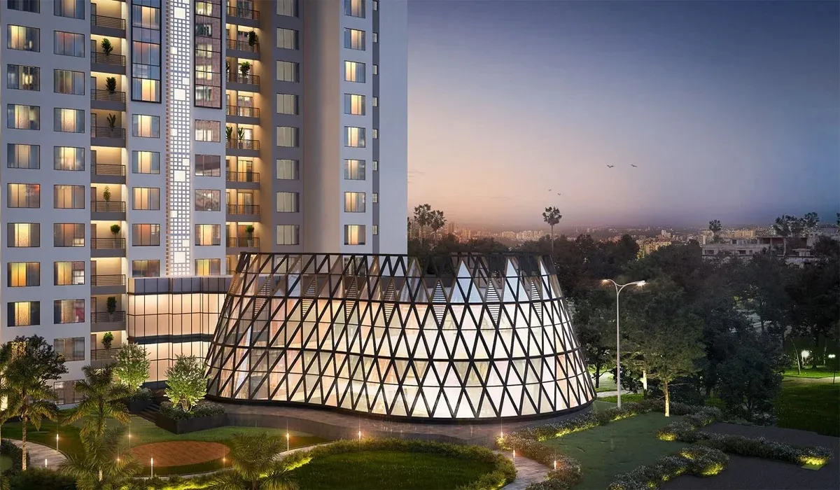 DLF Arbour Senior Living Gurgaon modern high-rise with illuminated balconies and iconic glass architectural structure at dusk.
