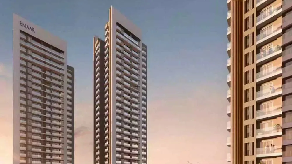 Emaar Serenity Hills modern high-rise buildings with EMAAR branding during sunset, showcasing contemporary urban living.