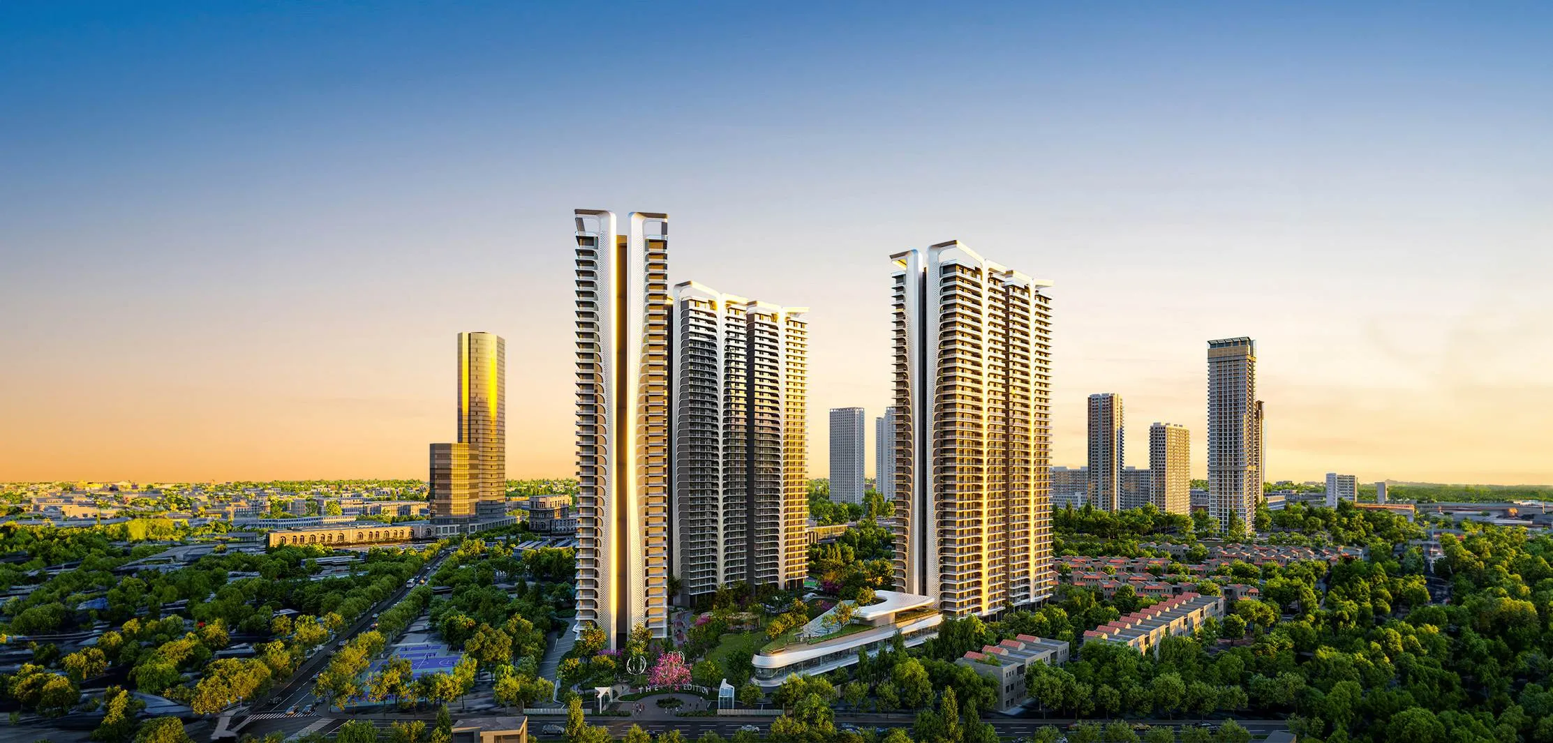 Illuminated residential towers and clubhouse at Smart World The Edition with landscaped pool and city backdrop.