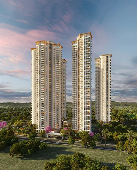 Modern high-rise residential towers at Tarc Ishva surrounded by landscaped greenery during sunset